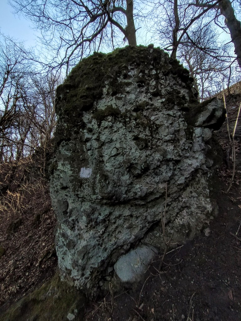 Cone-shaped rock formation at the side of the trail