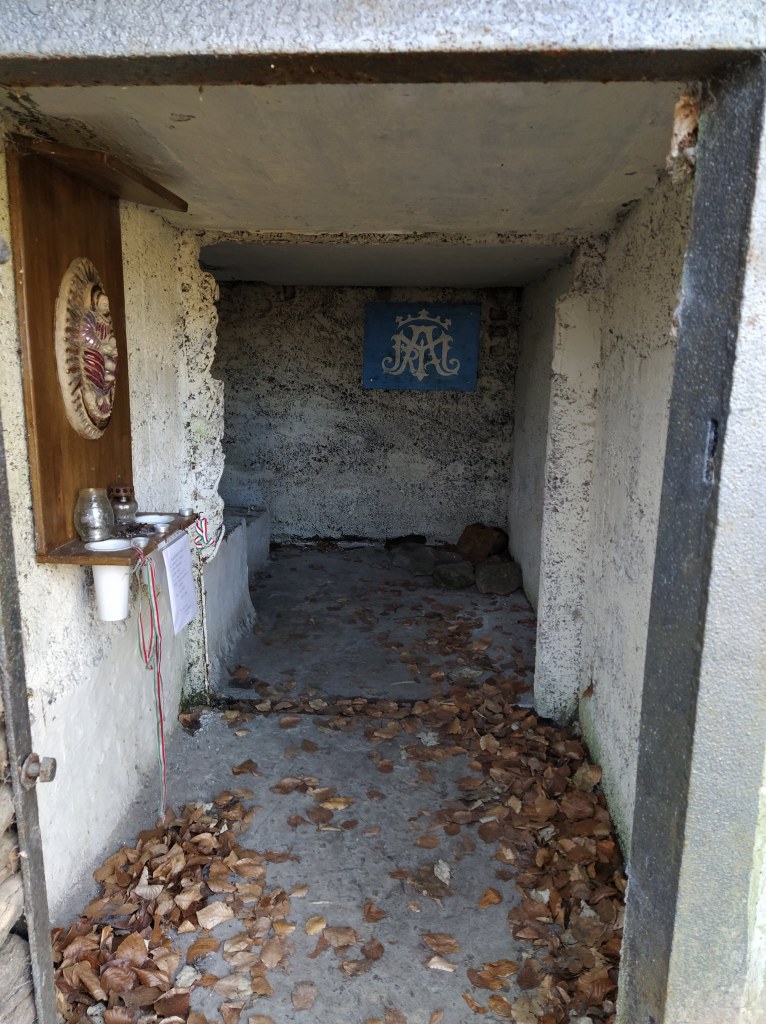 The inside of the well house with a little shrine