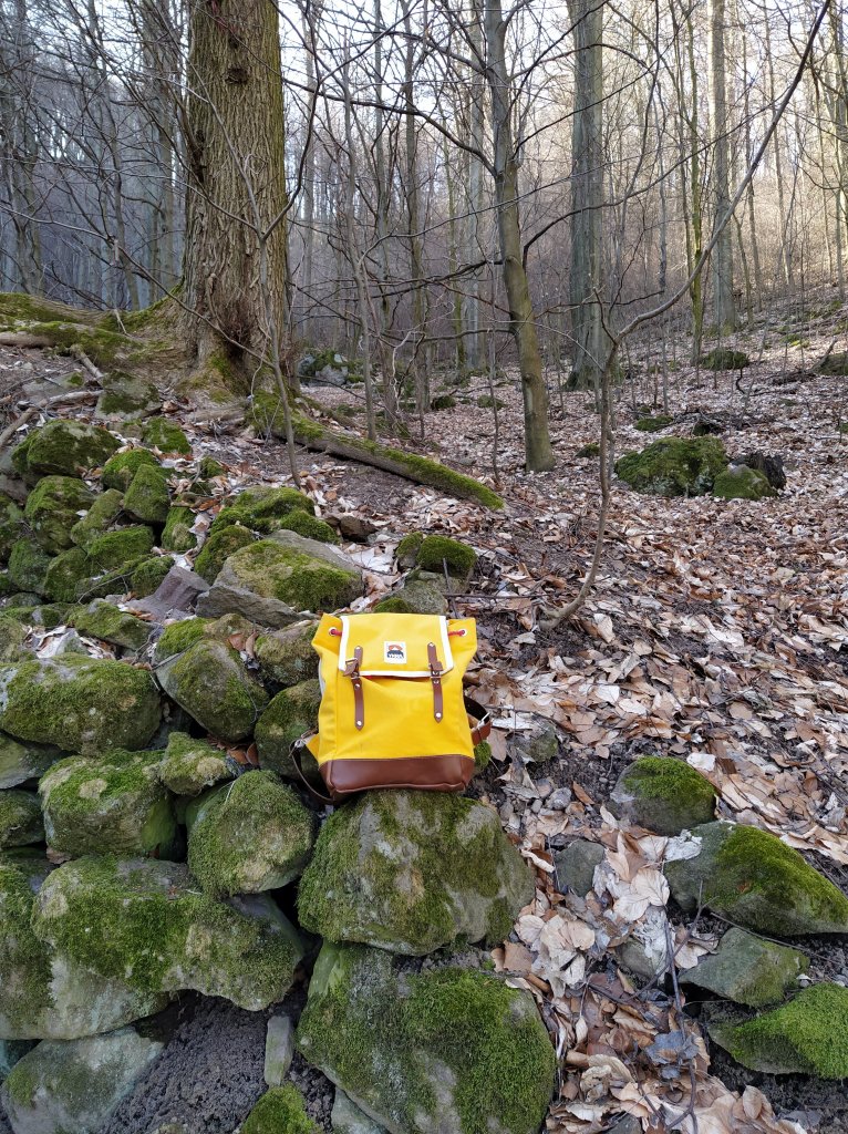 Yellow backpack on a rock wall